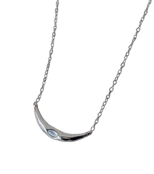 Silver necklace with a curved pendant on a white background